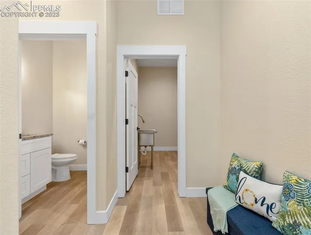a bathroom with a granite countertop sink and toilet