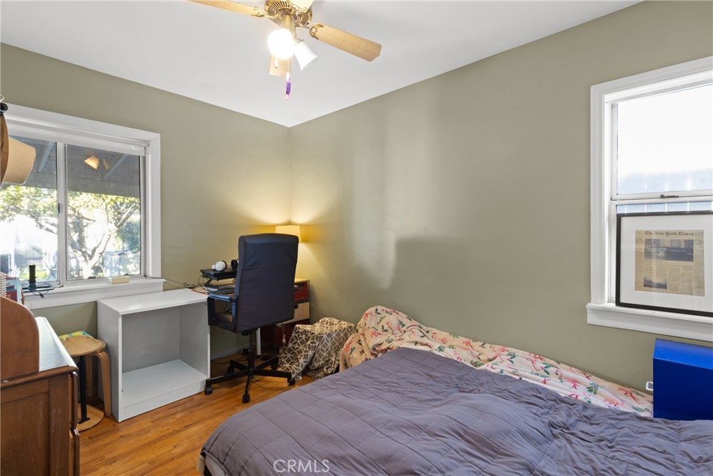 17415 Collins Street Encino, CA 91316 - Photo 8 of 14 a workspace with furniture window and wooden floor