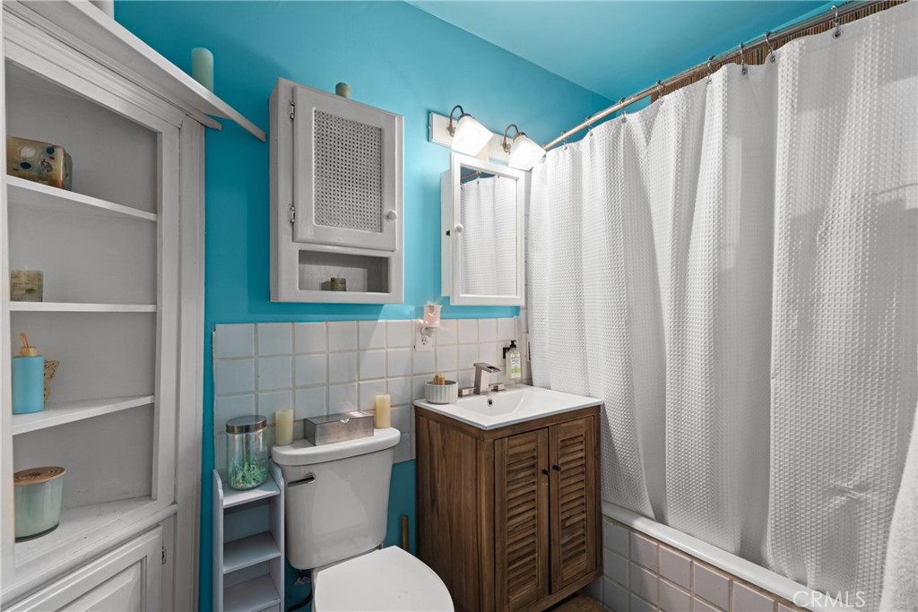 17415 Collins Street Encino, CA 91316 - Photo 9 of 14 a bathroom with a sink a toilet and a mirror