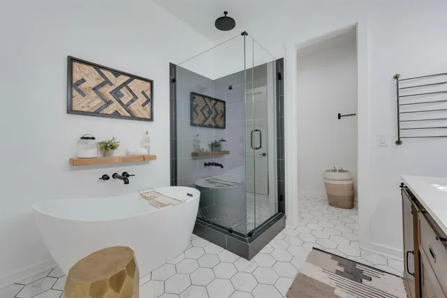 a spacious bathroom with a double vanity sink toilet and shower