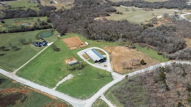 an aerial view of a house with a yard