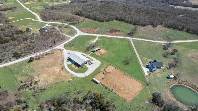 an aerial view of a house with a yard basket ball court