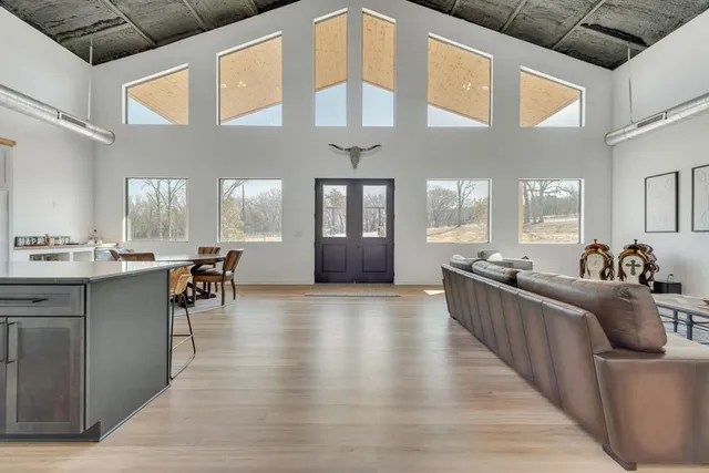 a view of living room with furniture and kitchen view