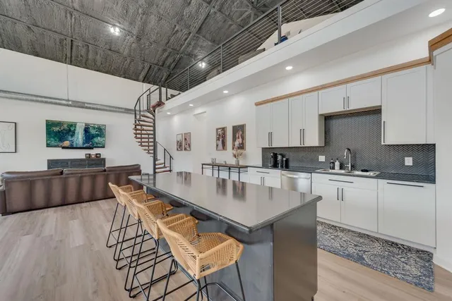 a kitchen with stainless steel appliances granite countertop white cabinets and a stove