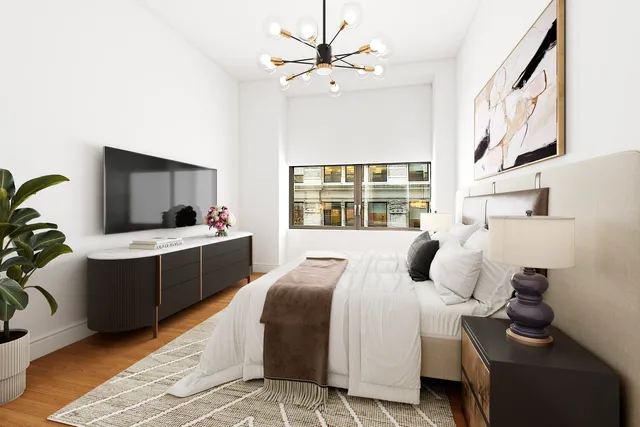 a bedroom with a bed and a chandelier