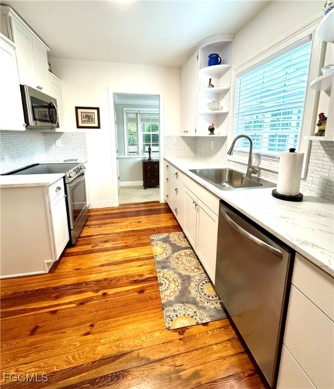 1640 Marlyn Road Fort Myers, FL 33901 - Photo 15 of 48 a large kitchen with kitchen island granite countertop a sink and a stove top oven