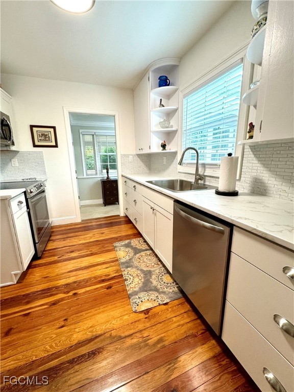 1640 Marlyn Road Fort Myers, FL 33901 - Photo 21 of 48 a large kitchen with granite countertop a sink dishwasher stove and cabinets