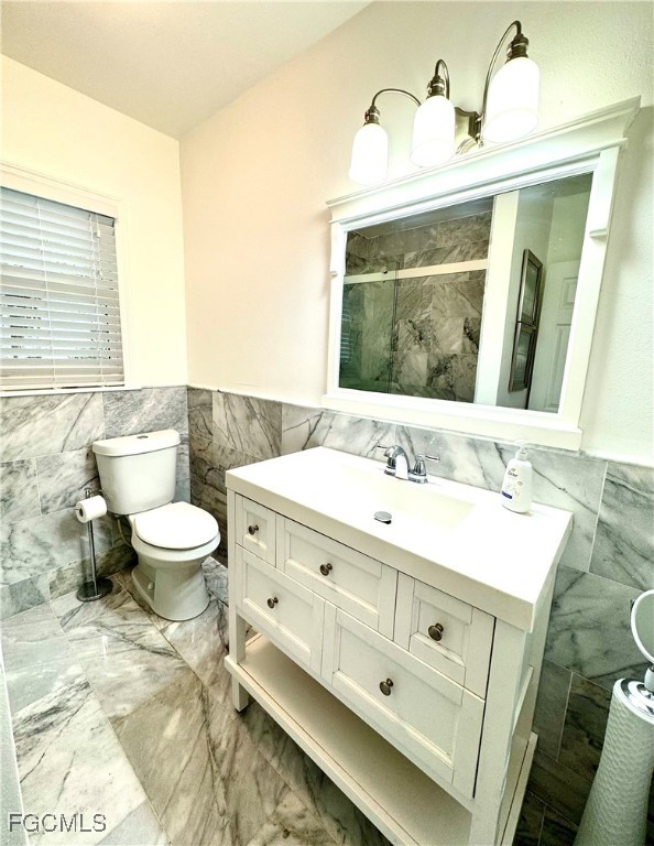 1640 Marlyn Road Fort Myers, FL 33901 - Photo 38 of 48 a bathroom with a toilet sink and mirror