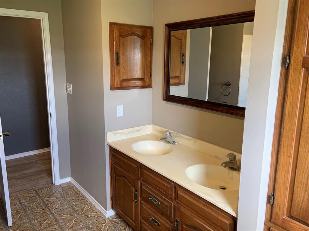 781 January Lane Ponder, TX 76259 - Photo 19 of 25 a bathroom with a sink and a mirror