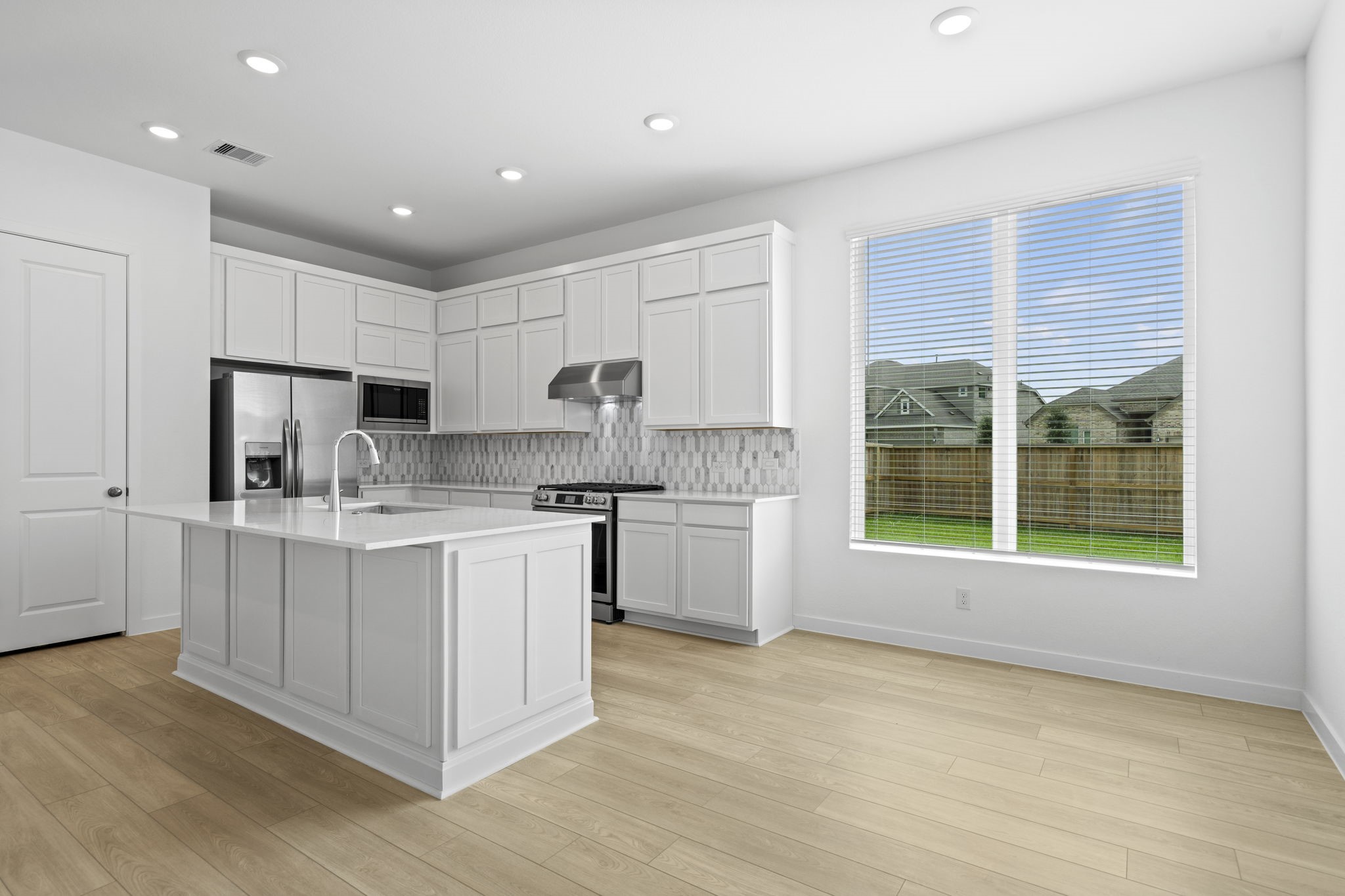 2720 Grove Crest Drive Rosenberg, TX 77469 - Photo 13 of 32 Light-filled dining area seamlessly connected to the gourmet kitchen, creating the perfect space for everyday living and entertaining.
