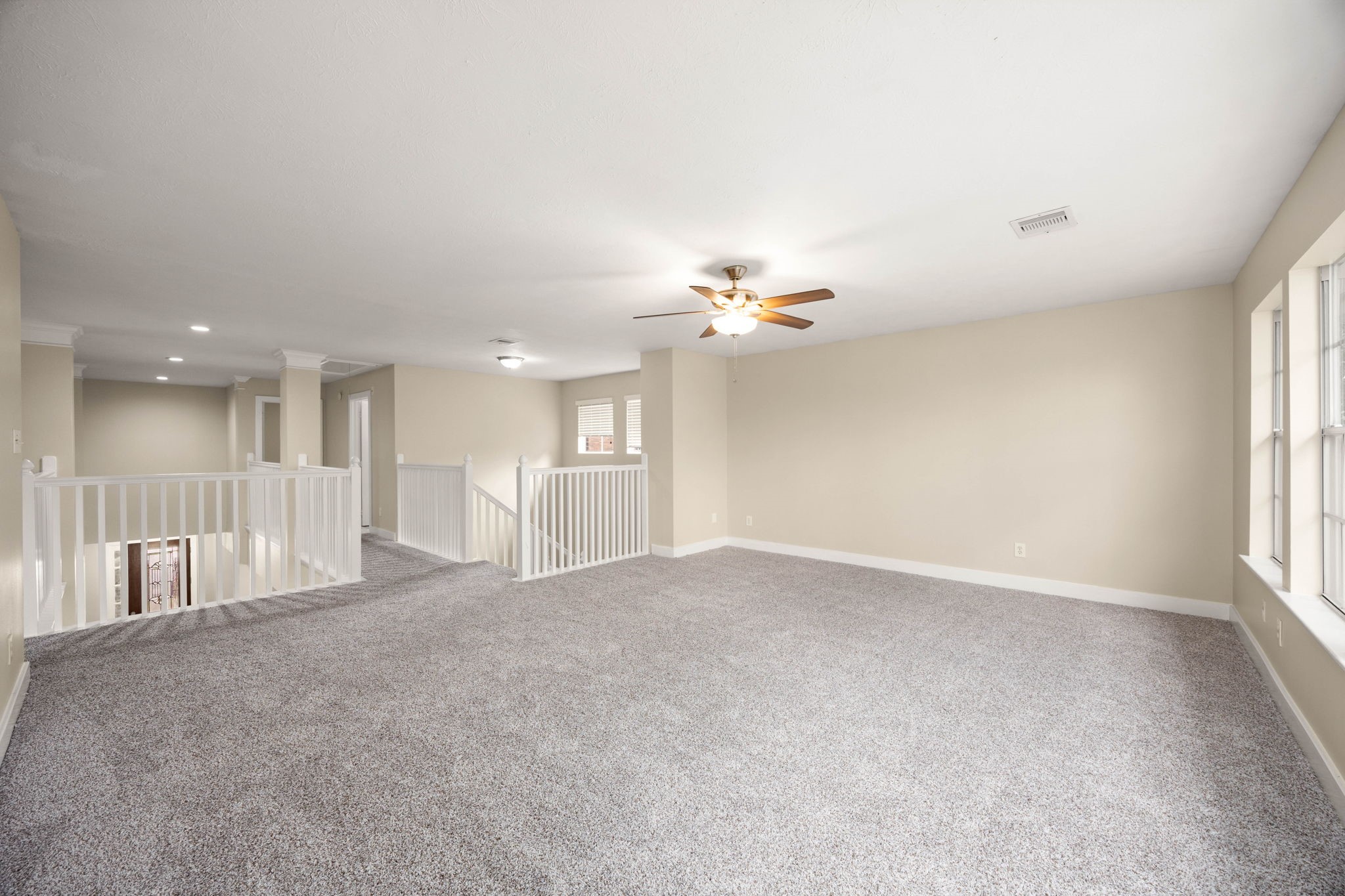 6335 Borg Breakpoint Drive Spring, TX 77379 - Photo 19 of 39 Spacious upstairs game room featuring plush carpet, ceiling fan, and abundant natural light.