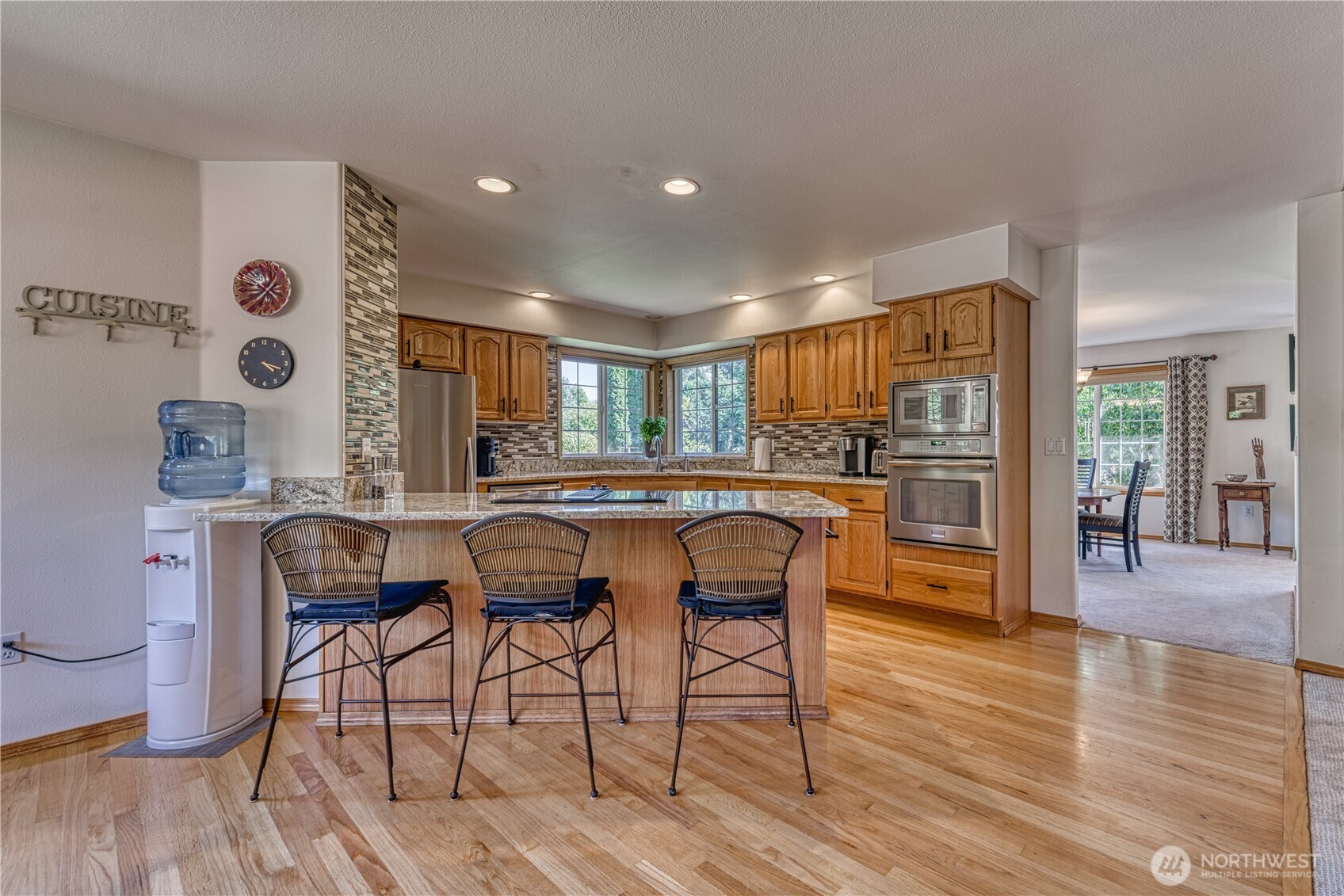 9705 346th Street South Roy, WA 98580 - Photo 12 of 34 a dining room with furniture and wooden floor
