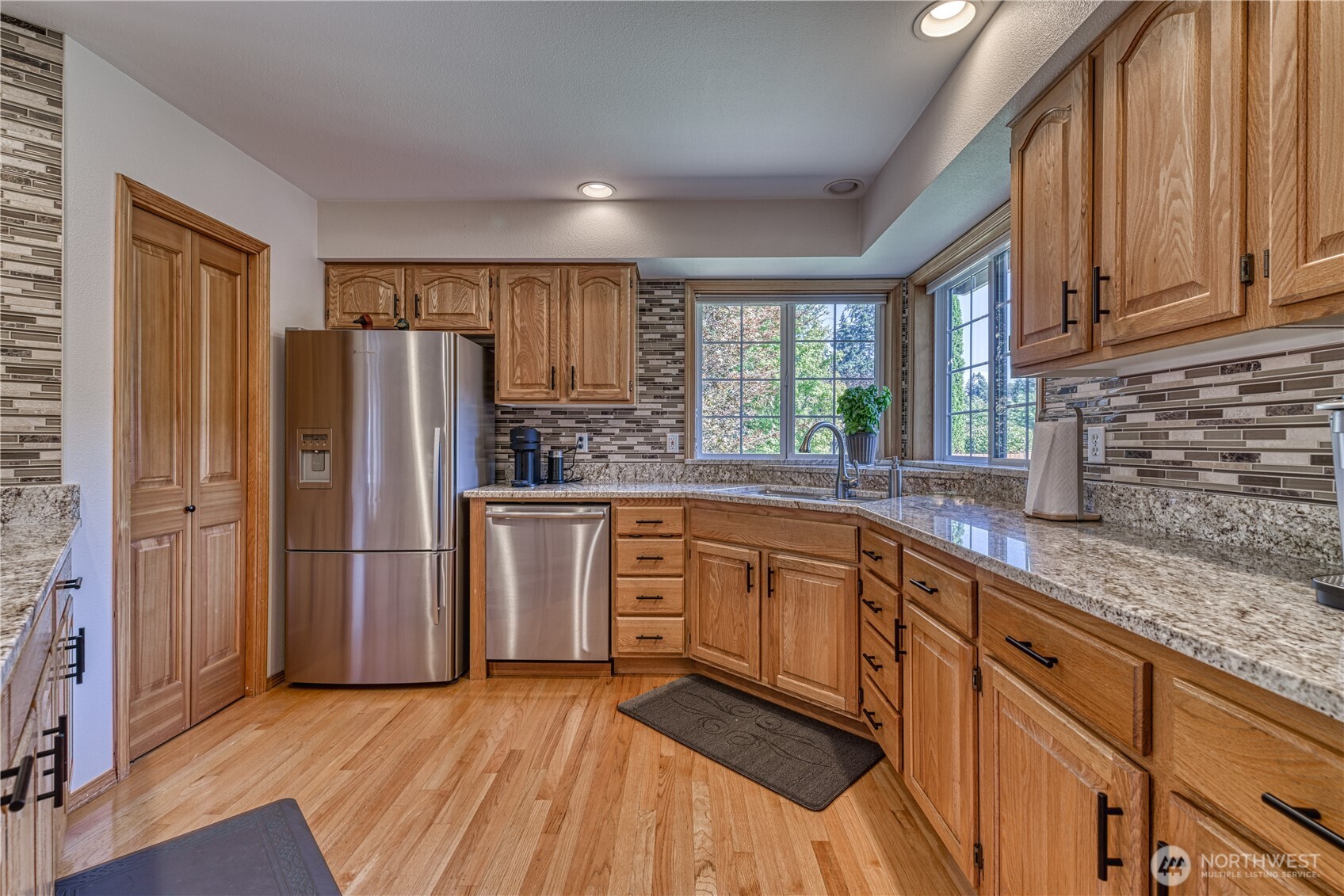 9705 346th Street South Roy, WA 98580 - Photo 13 of 34 a kitchen with stainless steel appliances granite countertop a refrigerator and a sink