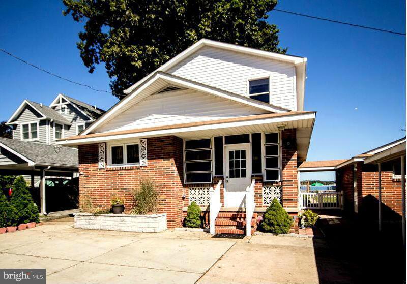 1929 Wilson Point Road Baltimore, MD 21220 - Photo 2 of 30 a front view of a house with the porch
