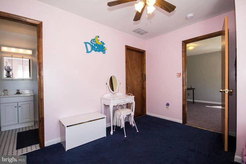 1929 Wilson Point Road Baltimore, MD 21220 - Photo 20 of 30 a living room with furniture and a chandelier