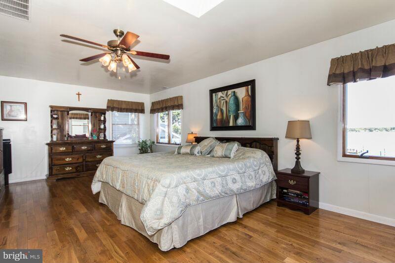 1929 Wilson Point Road Baltimore, MD 21220 - Photo 21 of 30 a bedroom with a bed and wooden floor