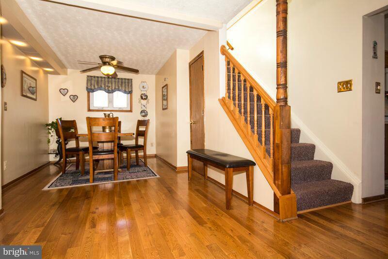 1929 Wilson Point Road Baltimore, MD 21220 - Photo 6 of 30 a view of a hallway with wooden floor and staircase