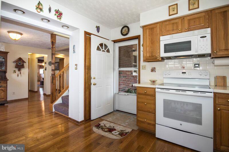 1929 Wilson Point Road Baltimore, MD 21220 - Photo 8 of 30 a kitchen with stainless steel appliances white cabinets a stove and a refrigerator