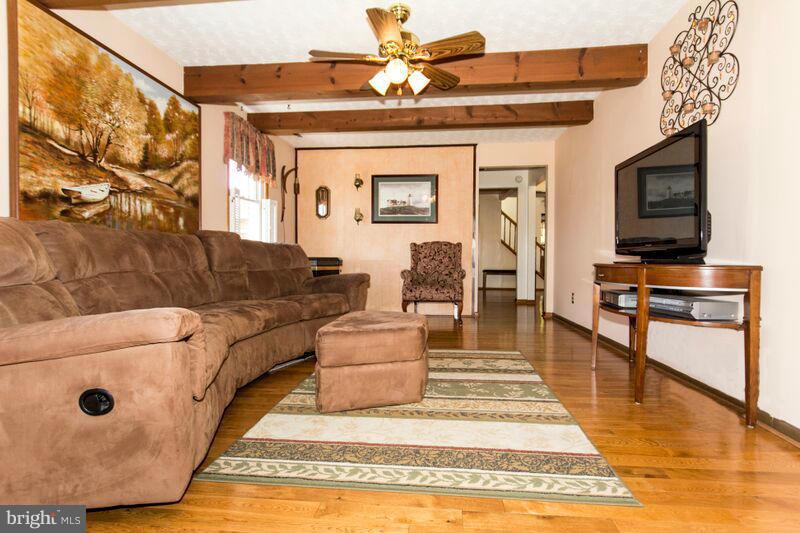 1929 Wilson Point Road Baltimore, MD 21220 - Photo 10 of 30 a living room with furniture and a flat screen tv