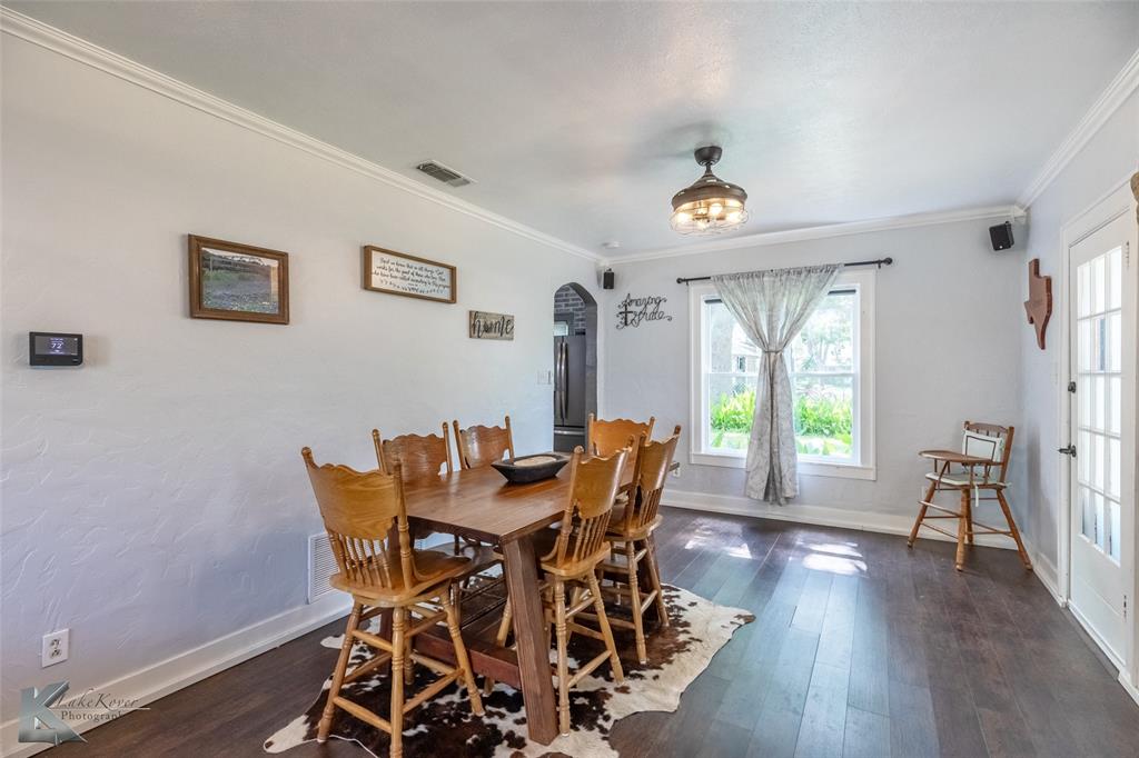 202 East Ross Street Rising Star, TX 76471 - Photo 9 of 40 a view of a dining room with furniture window and wooden floor