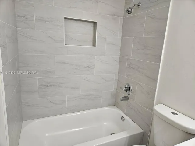 a bathroom with a sink and mirror with toilet