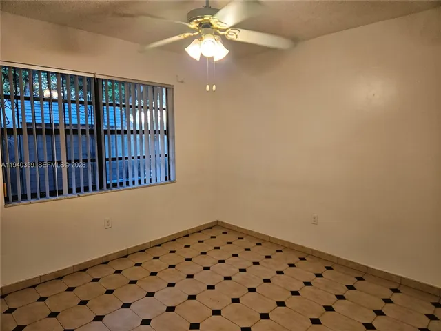 a bathroom with a black white checkered floor
