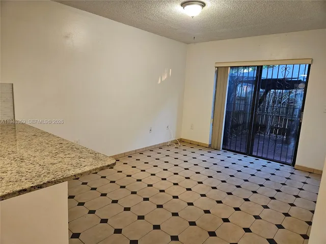 a bathroom with a black white checkered floor