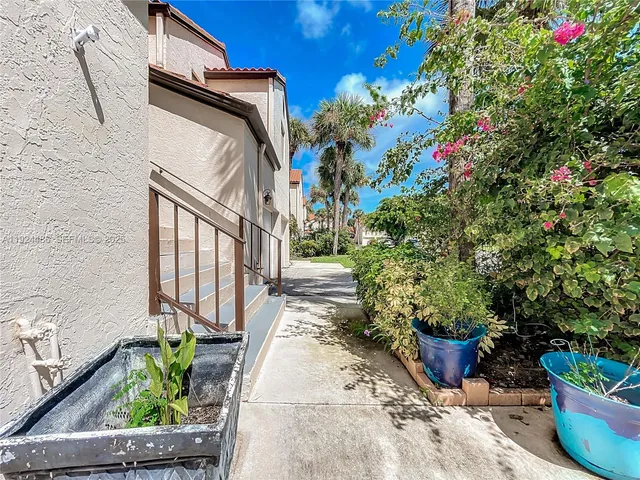 a view of a kitchen with a sink and a living room view