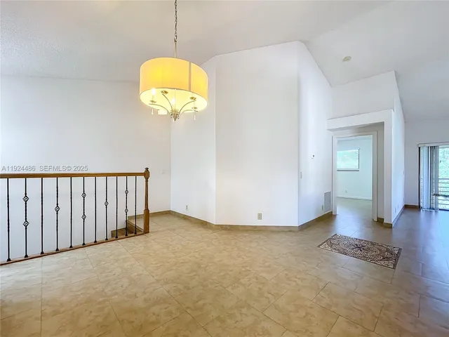 a kitchen with granite countertop white cabinets stainless steel appliances and a counter space