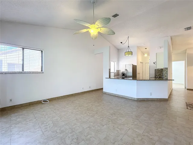 a view of an empty room with windows