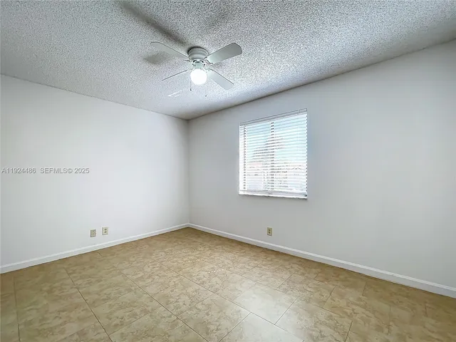 a view of a room that has a large window and a yard