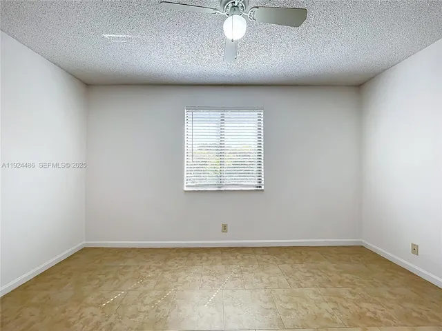 a view of a room with wooden floor and windows