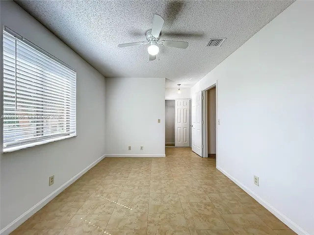 a view of a house with a yard and deck
