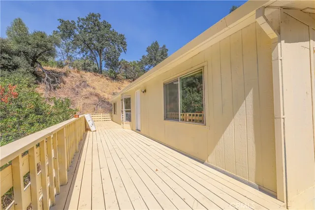 a view of balcony with wooden floor and fence