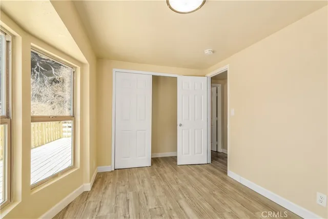 a view of an empty room with glass door