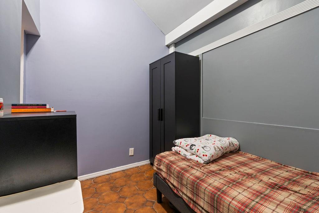 32 Brighton 2nd Place Brooklyn, NY 11235 - Photo 17 of 23 a bedroom with a bed and a potted plant