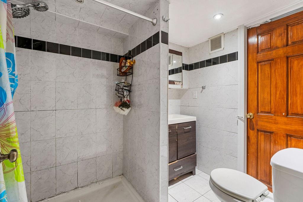 32 Brighton 2nd Place Brooklyn, NY 11235 - Photo 21 of 23 a bathroom with a toilet and a shower