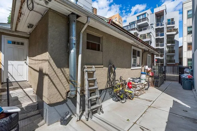 a bedroom with a bed couch and a window
