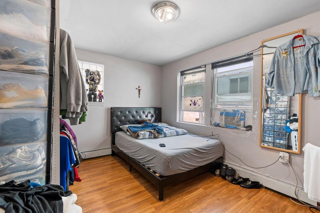 32 Brighton 2nd Place Brooklyn, NY 11235 - Photo 10 of 23 a bedroom with a bed couch and a window