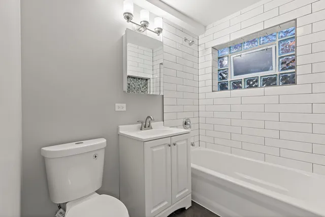 a bathroom with a toilet a sink and bathtub