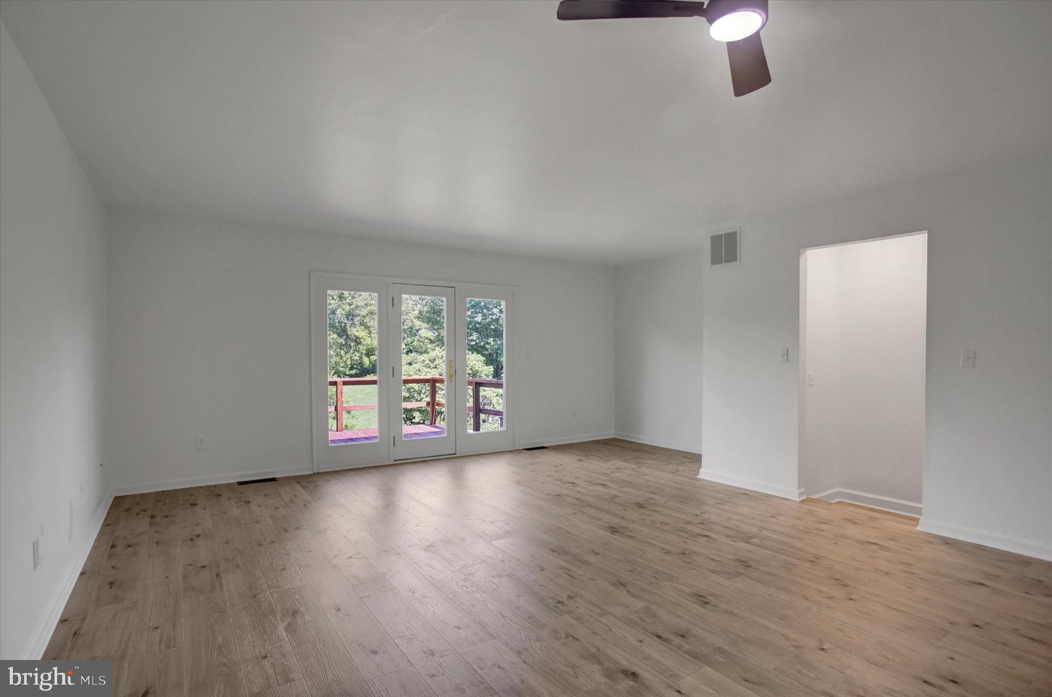 1553 Brechbill Road Chambersburg, PA 17202 - Photo 16 of 45 an empty room with wooden floor fan and windows