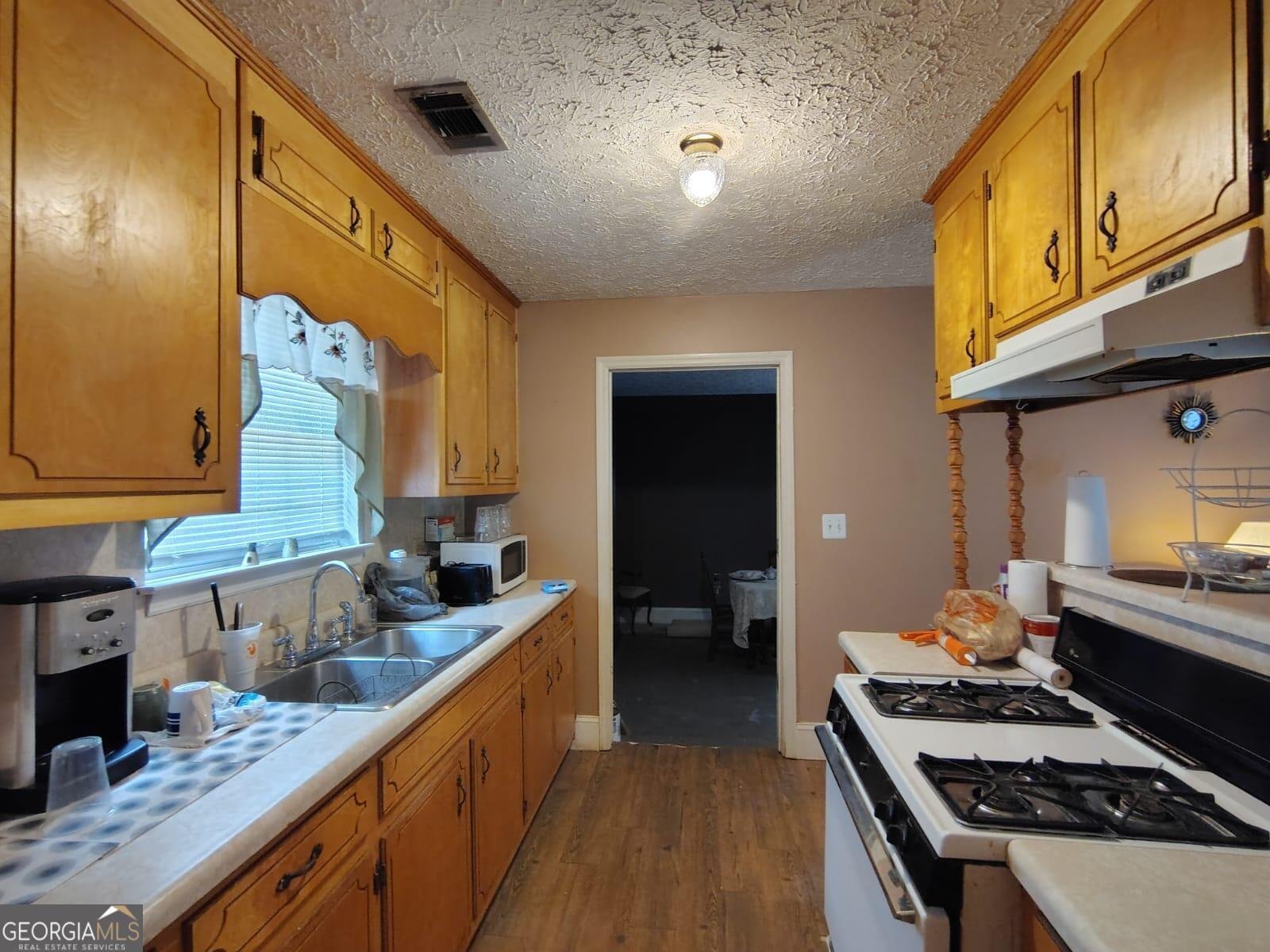 5576 Po Biddy Road Talbotton, GA 31827 - Photo 11 of 28 a kitchen with a stove and a sink