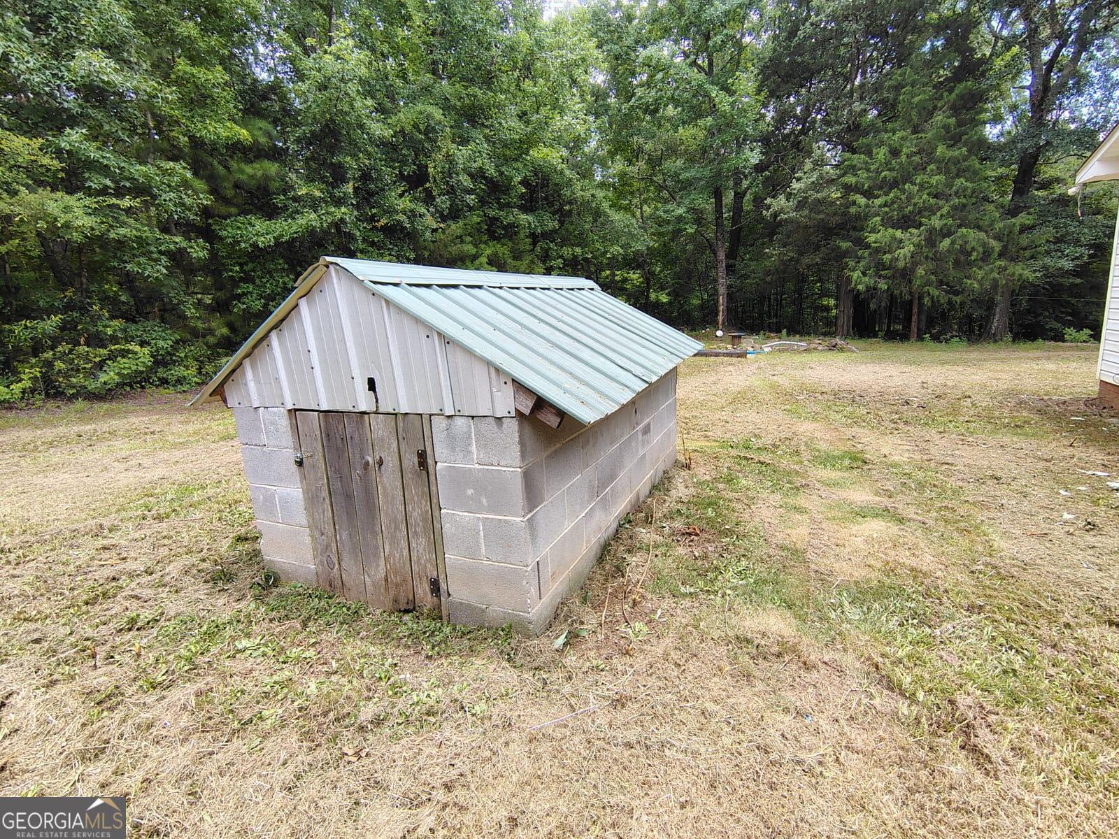 5576 Po Biddy Road Talbotton, GA 31827 - Photo 19 of 28 a view of a wooden house with large trees