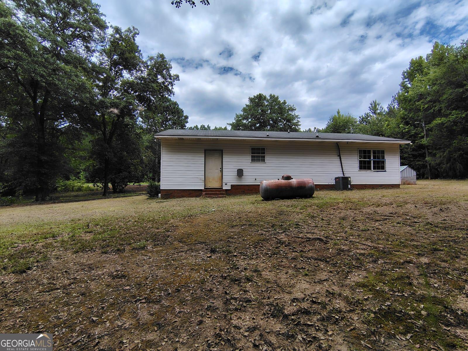 5576 Po Biddy Road Talbotton, GA 31827 - Photo 25 of 28 a front view of house with yard and trees