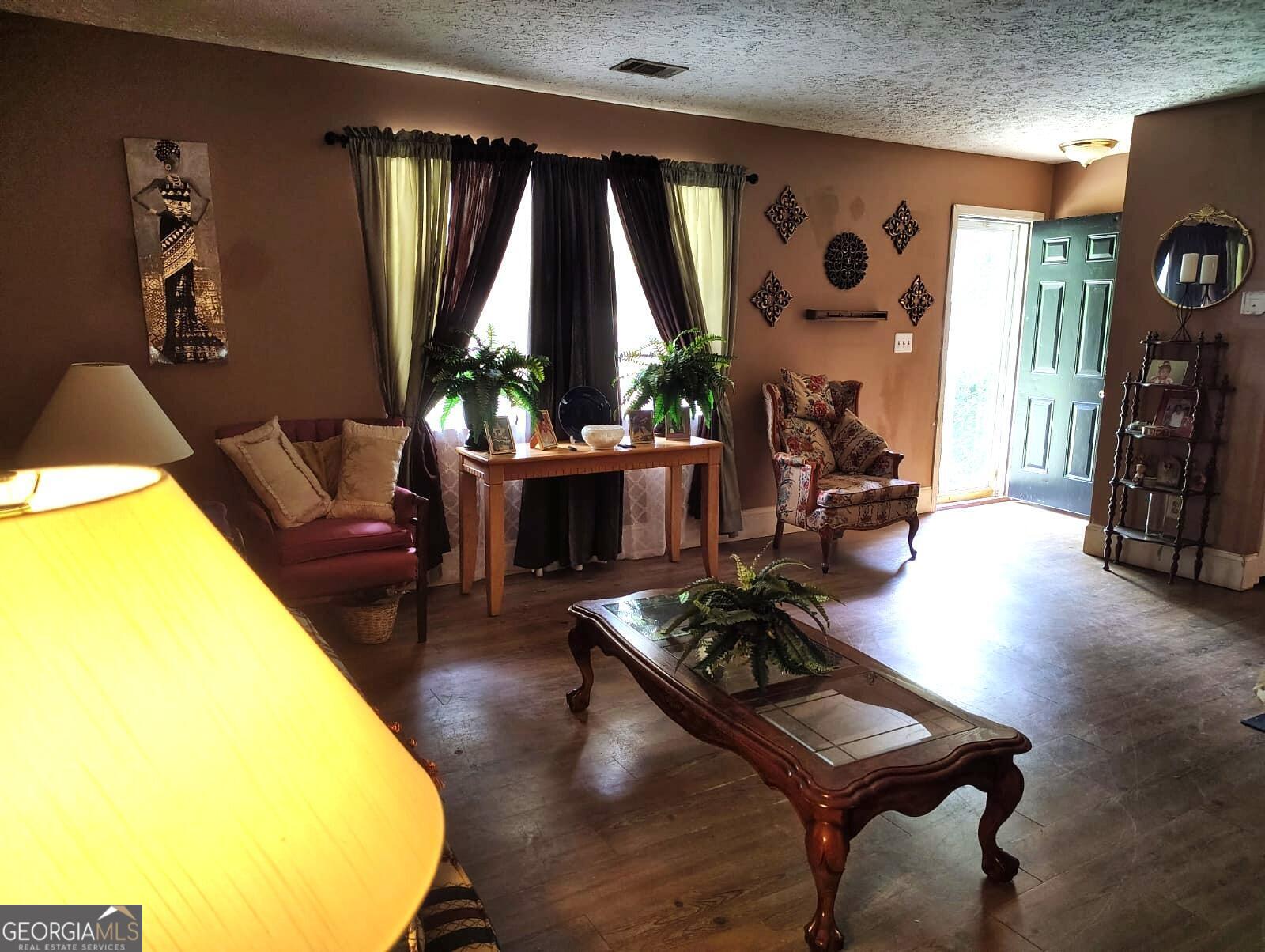 5576 Po Biddy Road Talbotton, GA 31827 - Photo 3 of 28 a living room with furniture and a large window