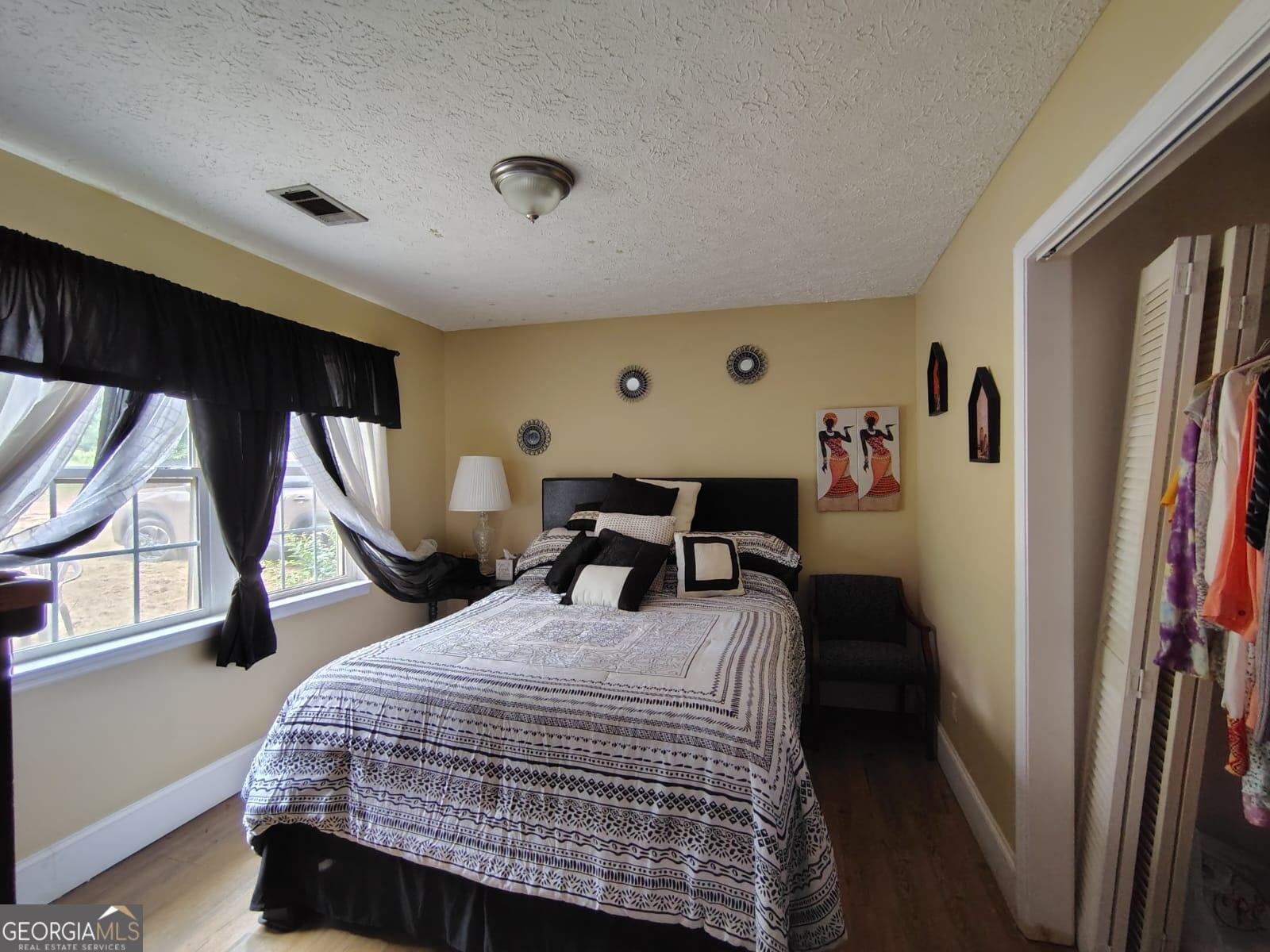 5576 Po Biddy Road Talbotton, GA 31827 - Photo 5 of 28 a bedroom with a bed and a window