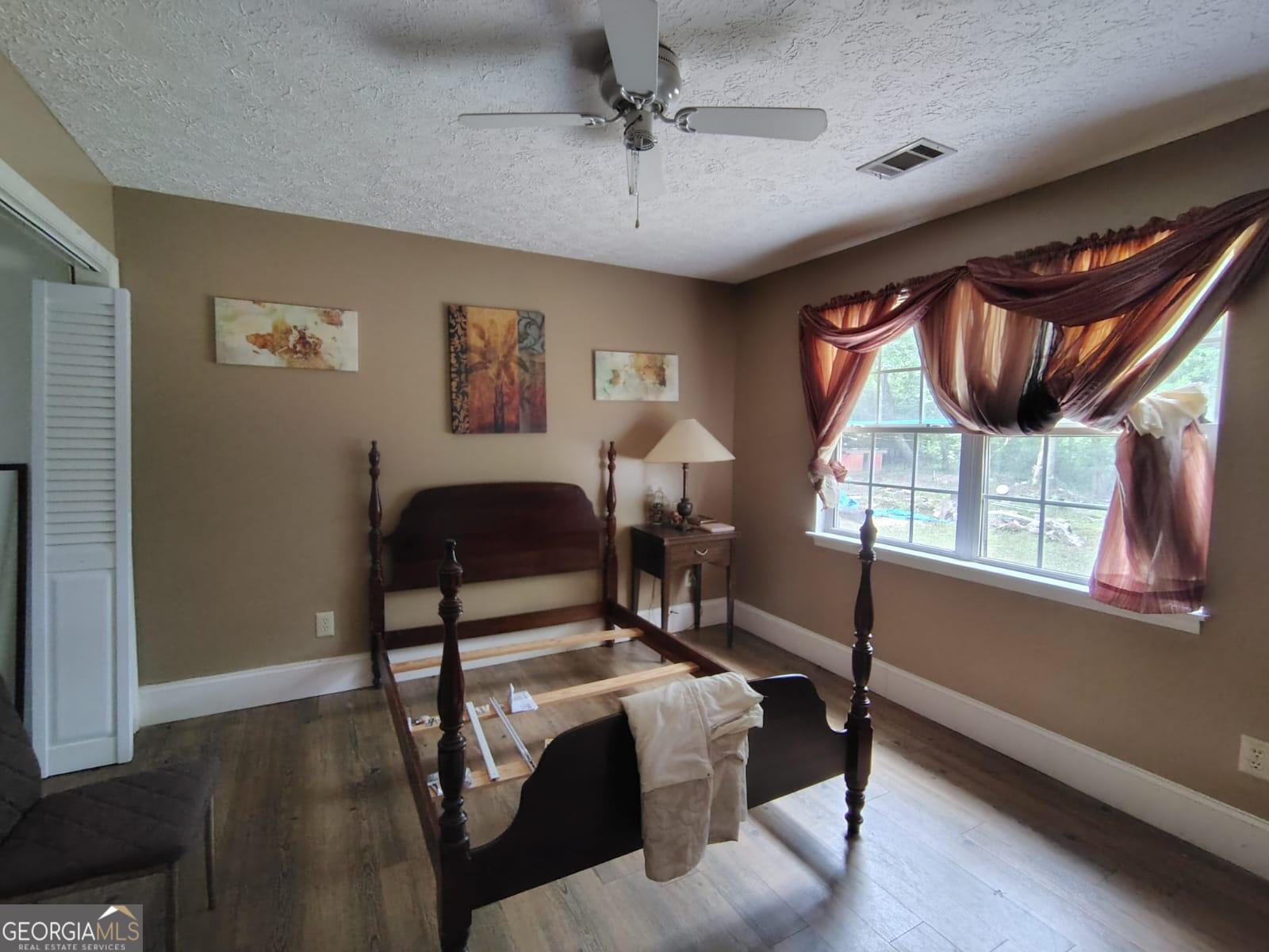 5576 Po Biddy Road Talbotton, GA 31827 - Photo 9 of 28 a bedroom with furniture and a window