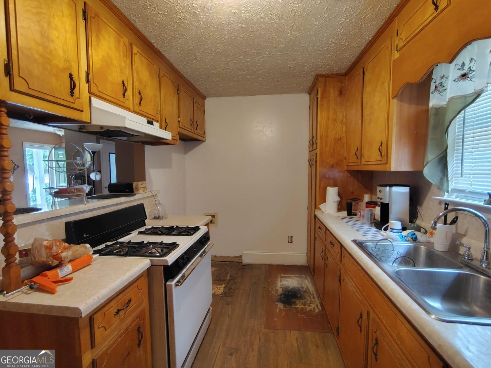 5576 Po Biddy Road Talbotton, GA 31827 - Photo 10 of 28 a kitchen with stainless steel appliances granite countertop a stove a sink and a refrigerator