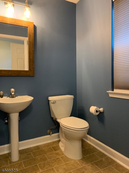 105 Well Sweep Road, Unit 105 Whitehouse Station, NJ 08889 - Photo 15 of 22 a bathroom with a toilet sink and mirror