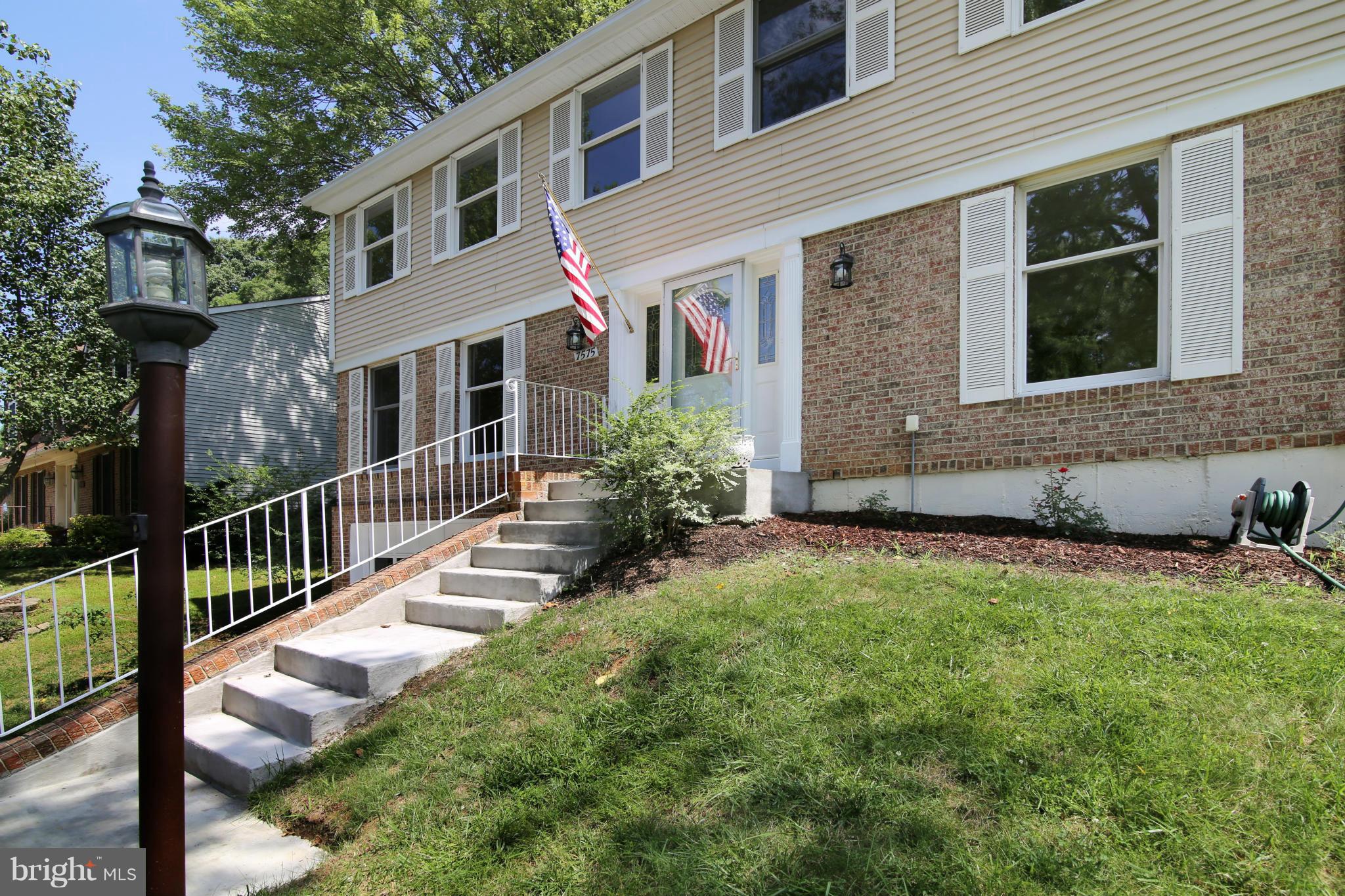 7575 Vogels Way Springfield, VA 22153 - Photo 3 of 30 a front view of a house with yard and green space